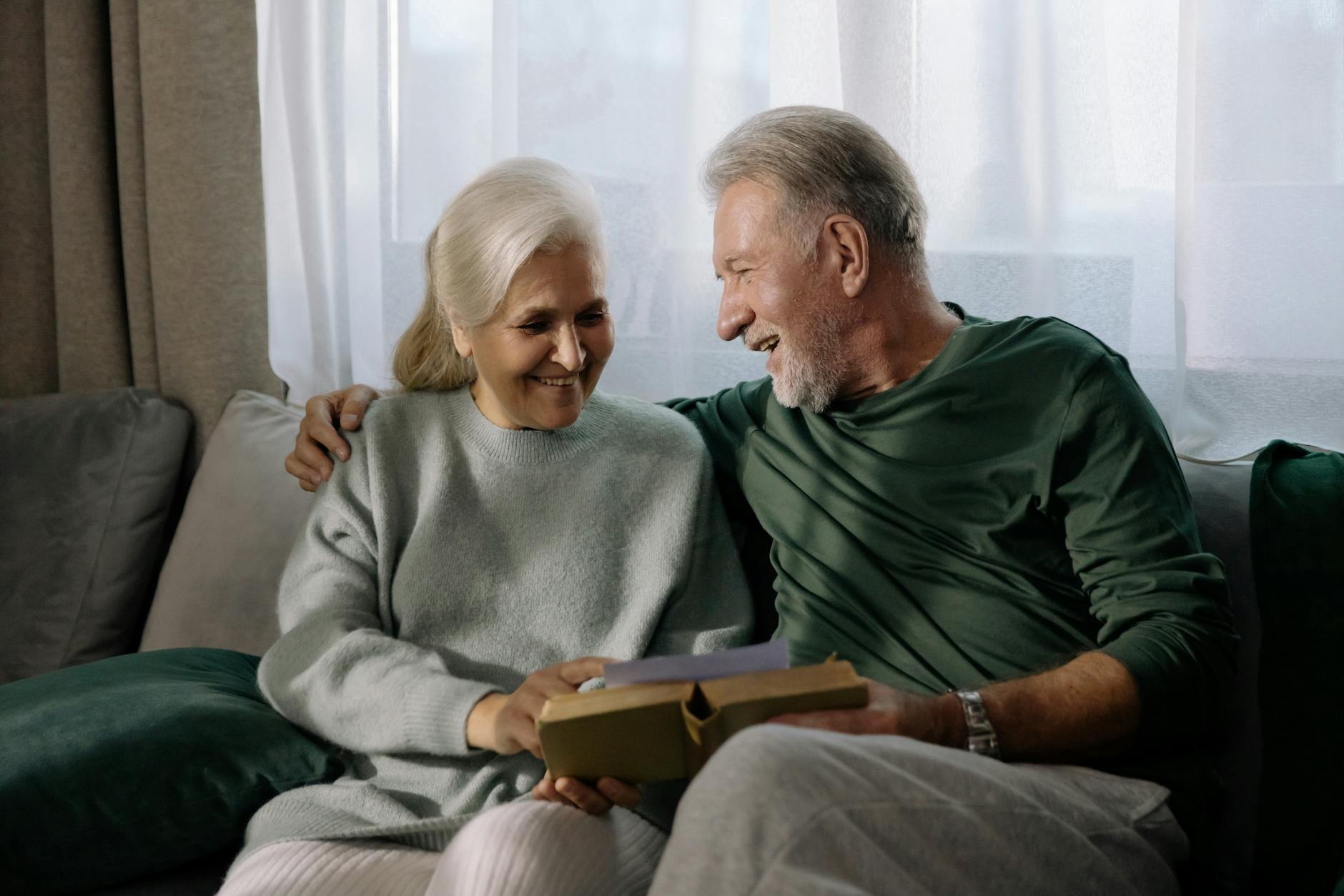 gray haired couple reading a book together